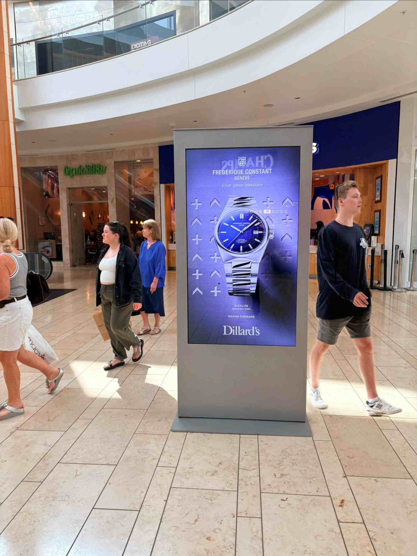Freestanding branded standee display inside a department store